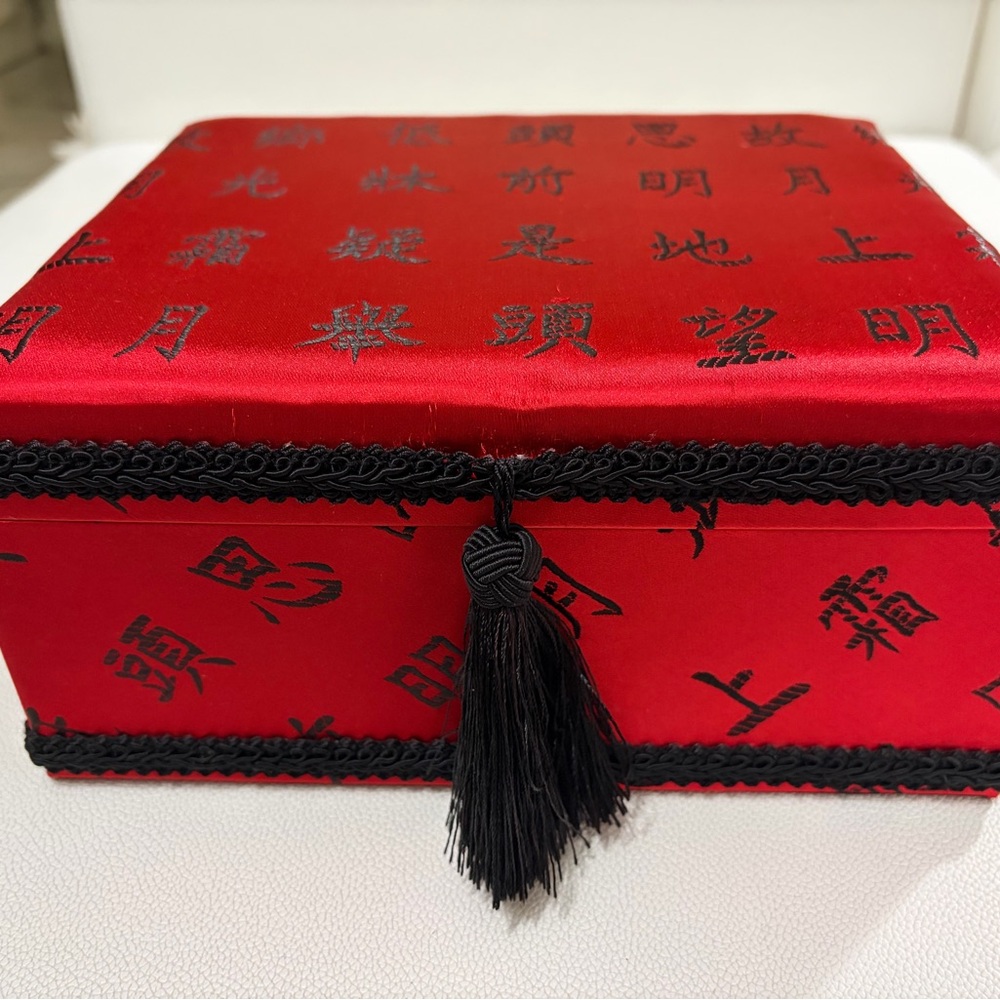 Vintage, luxurious red silk jewelry box with black characters